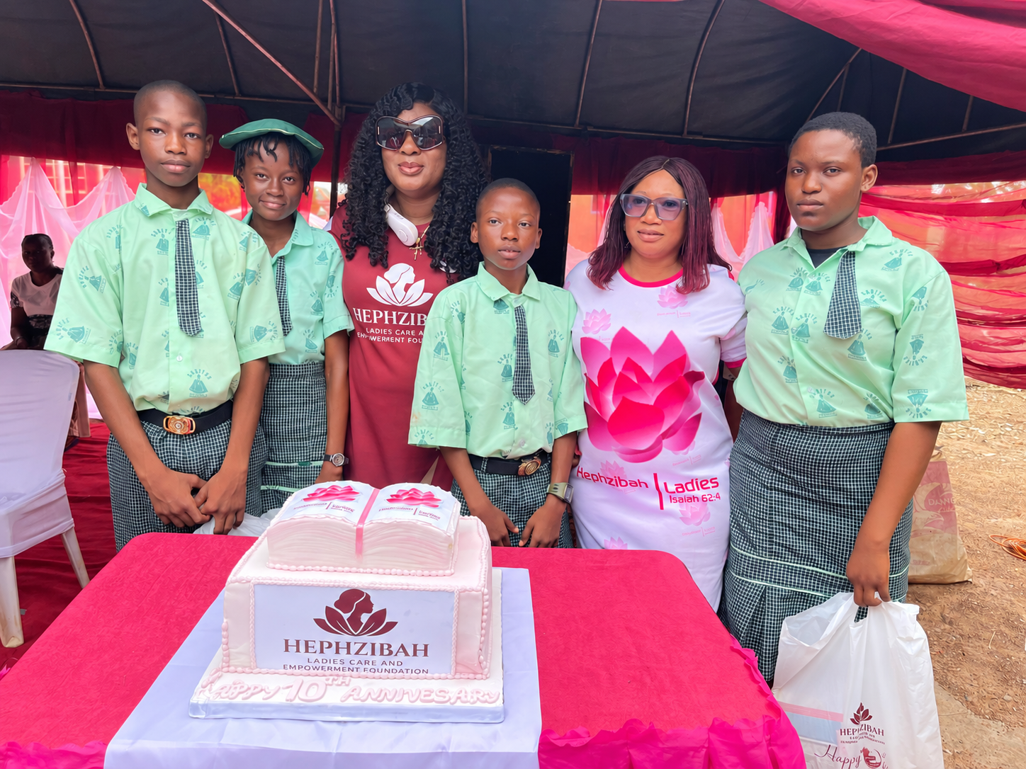 Founder, volunteers and children celebrating a decade of fellowship and community service